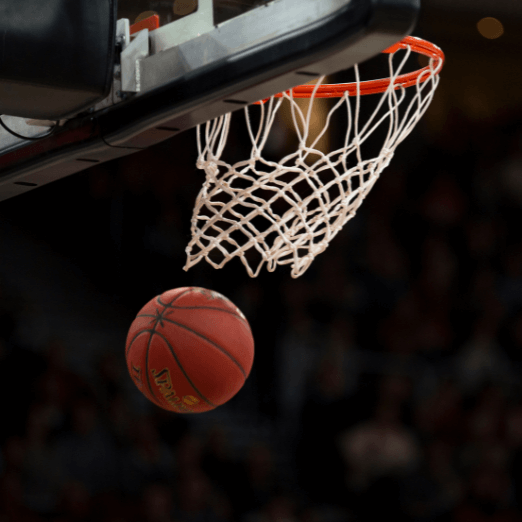 Photo of a basketball after passing through a basketball net.