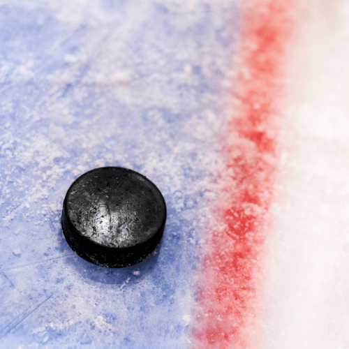 Photo of hockey puck on ice.