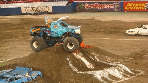 Photo of a Monster Jam truck on top of a dirt ramp.