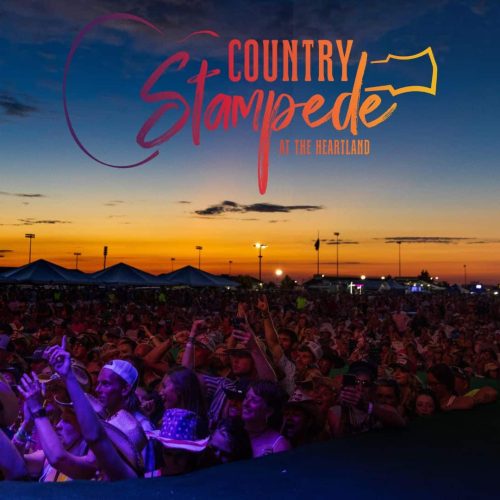 Photo of the crowd under a sunset with the Country Stampede logo at the top.