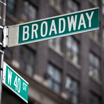 Green and white Broadway street sign