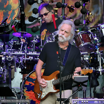 Bob Weir of Dead & Company performers on stage.