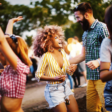 Photo of a woman talking to a man and laughing.