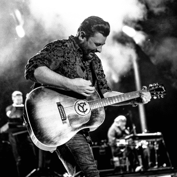 Black and white photo of Chris Young performing on stage.