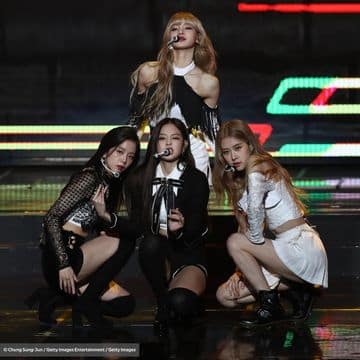 The four members of Blackpink gathered together on stage.