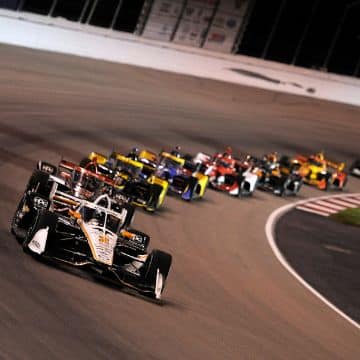 Photo from 2021 Bommarito Automotive Group 500 showing Josef Newgarden, driver of the #2 Sonsio Team Penske Chevrolet, leads the field through turn four on the way to a restart during the NTT IndyCar Series Bommarito Automotive Group 500 at World Wide Technology Raceway in Madison, Illinois.