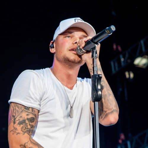 Photo of Kane Brown holding a microphone and performing.
