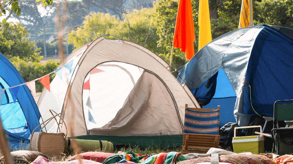 Tents in a row at a music festival.