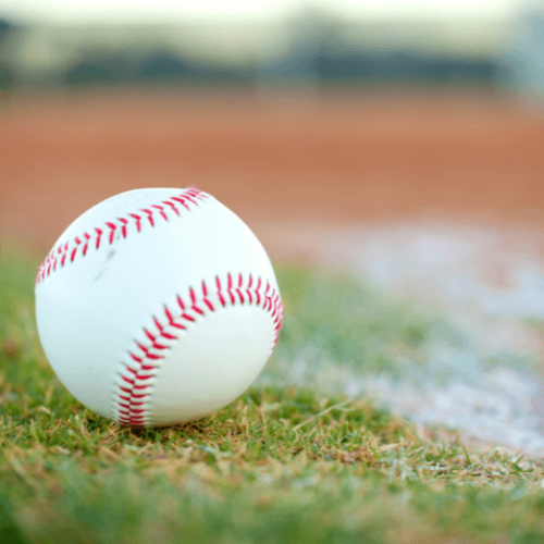 Photo of a baseball sitting on a pitchers mound.