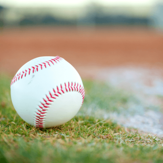 Photo of a baseball sitting on a pitchers mound.