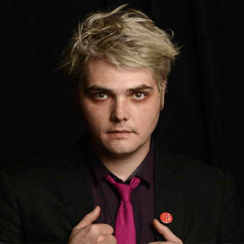 Image of Gerard Way wearing a black suit with a purple shirt and dark pink tie