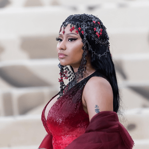 Image of Nicki Minaj wearing red gradient dress and a black headdress with red crosses and crystals