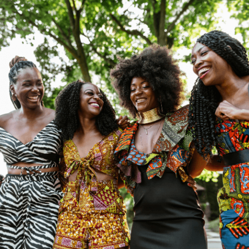 Image of four African-American women laughing together