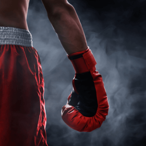 Image of boxer wearing red shorts and red boxing gloves